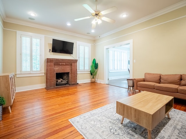 103 W Moore St, Valdosta, GA 31602 - living room with ornamental molding, light wood-style flooring, ceiling fan, a fireplace, and baseboards