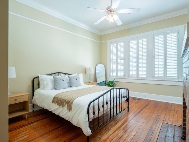 103 W Moore St, Valdosta, GA 31602 - bedroom with hardwood / wood-style floors, crown molding, baseboards, and ceiling fan