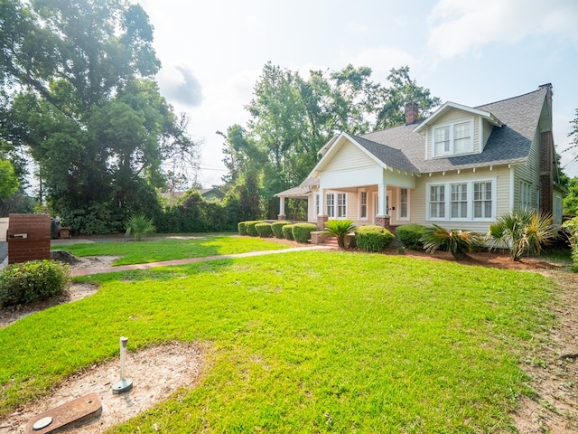 103 W Moore St, Valdosta, GA 31602 - bungalow-style house featuring a front yard, a porch, a chimney, and a shingled roof
