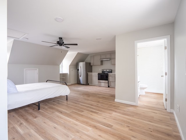 103 W Moore St, Valdosta, GA 31602 - bedroom featuring stainless steel fridge, light wood-style floors, baseboards, vaulted ceiling, and ceiling fan