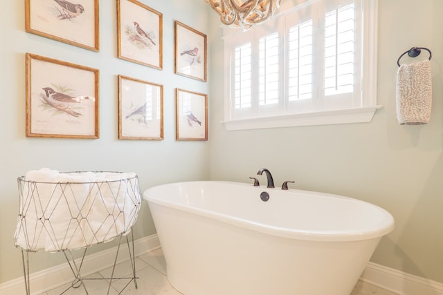 7351 Woodbend Trl, Hahira, GA 31632 - bathroom featuring a soaking tub, a chandelier, and tile patterned flooring