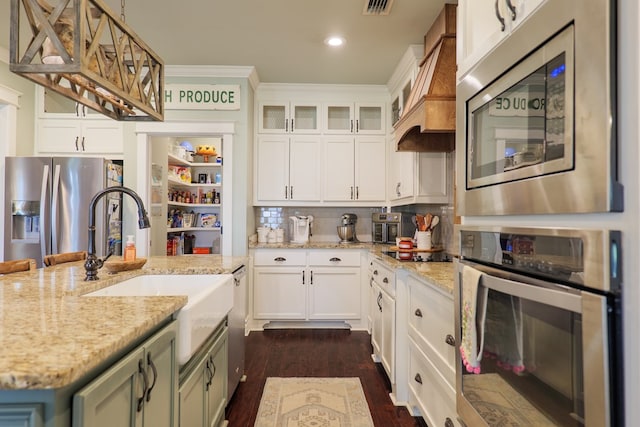 7351 Woodbend Trl, Hahira, GA 31632 - kitchen featuring appliances with stainless steel finishes, white cabinets, light stone countertops, dark wood finished floors, and glass insert cabinets