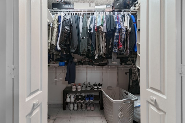 spacious closet featuring tile patterned flooring