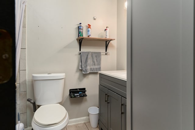 bathroom featuring tile patterned floors, vanity, and toilet