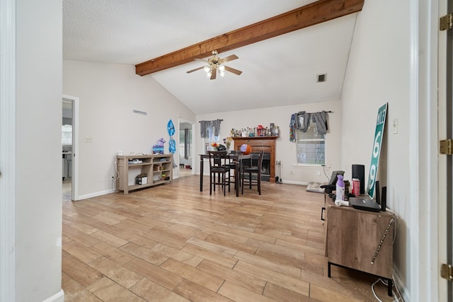 dining room with ceiling fan, plenty of natural light, a textured ceiling, and light wood-type flooring