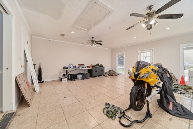 miscellaneous room with light tile patterned floors, a textured ceiling, ceiling fan, and ornamental molding