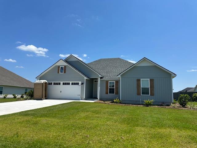 view of front of property with a garage and a front lawn