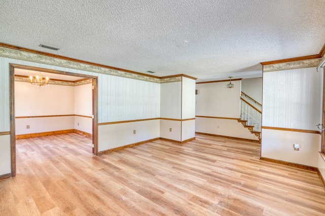 living room with a textured ceiling, ceiling fan, crown molding, a fireplace, and hardwood / wood-style floors