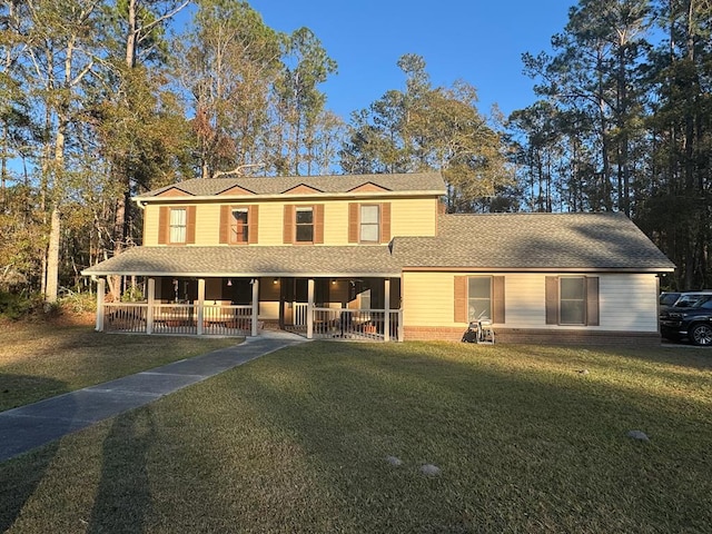 farmhouse featuring a front lawn and a porch