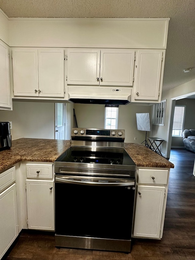 2761 Tyndall Dr, Valdosta, GA 31602 - kitchen with stainless steel electric range, under cabinet range hood, white cabinetry, and a textured ceiling