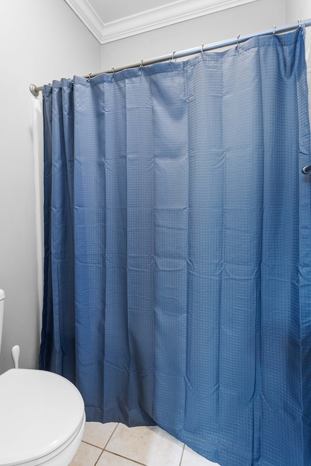 bathroom featuring a shower with curtain, tile patterned flooring, ornamental molding, and toilet