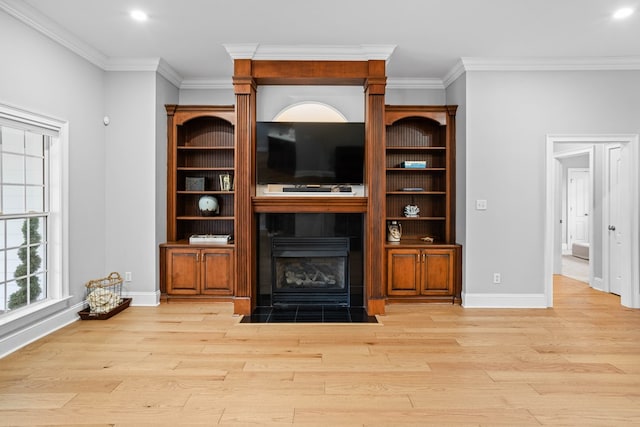 living room with light wood-type flooring and ornamental molding