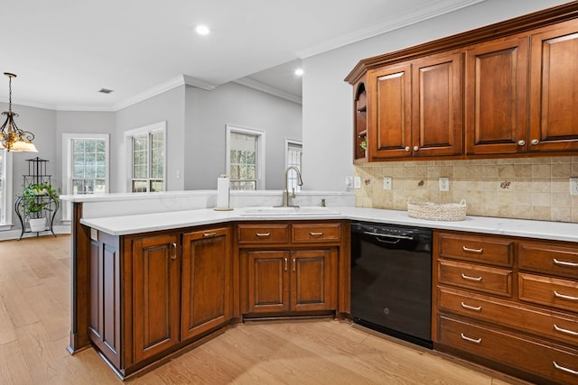 kitchen featuring kitchen peninsula, ornamental molding, sink, decorative light fixtures, and dishwasher