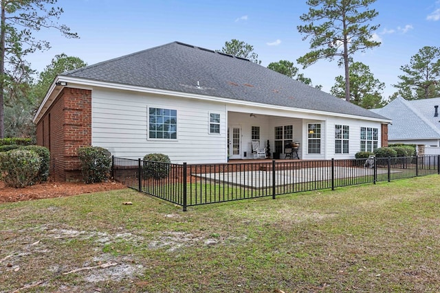 rear view of property with a yard, ceiling fan, and a patio area