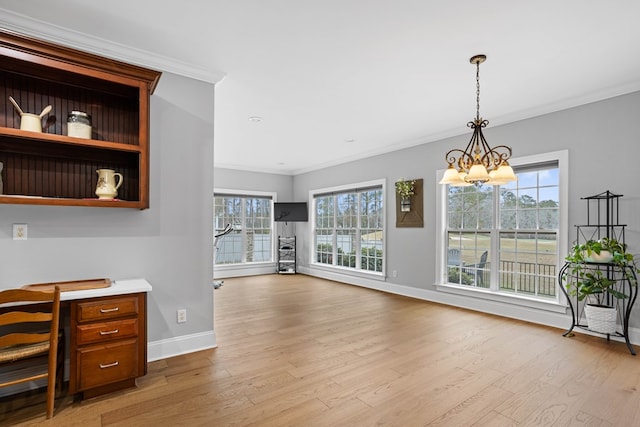 interior space featuring a notable chandelier, crown molding, and a wealth of natural light