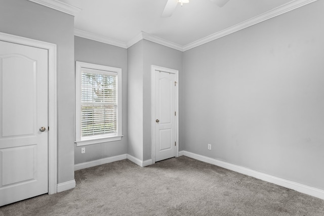 unfurnished bedroom featuring ceiling fan, light colored carpet, and ornamental molding