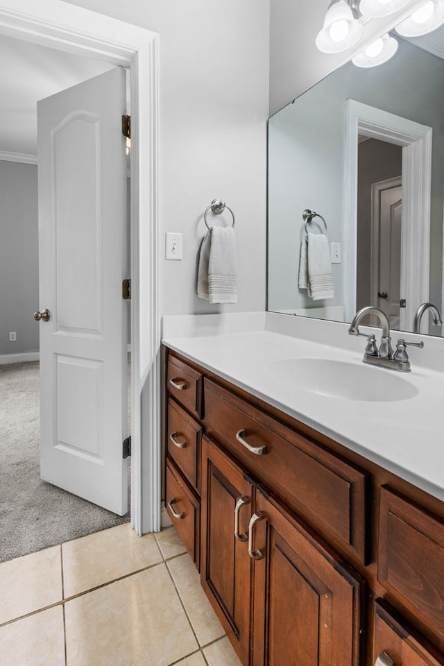 bathroom featuring tile patterned flooring, vanity, and ornamental molding