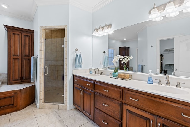 bathroom with tile patterned flooring, vanity, a shower with door, and ornamental molding