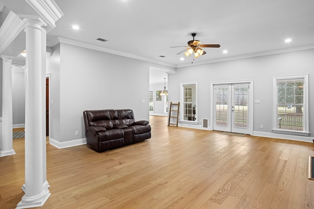 living room featuring ceiling fan, light hardwood / wood-style floors, ornate columns, and ornamental molding