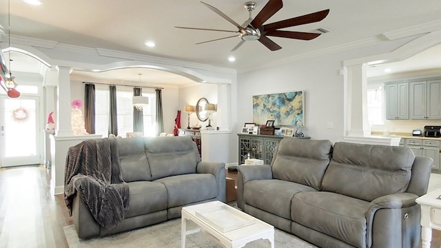 living room with ceiling fan, light hardwood / wood-style flooring, and ornamental molding