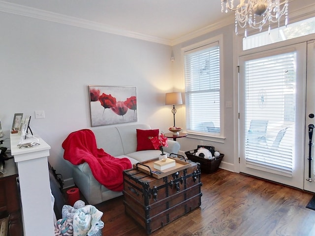 sitting room with dark hardwood / wood-style flooring, plenty of natural light, a chandelier, and ornamental molding