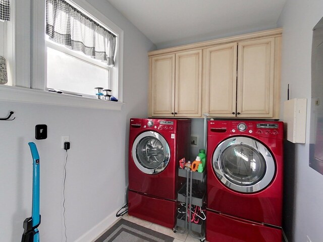 clothes washing area with cabinets and independent washer and dryer