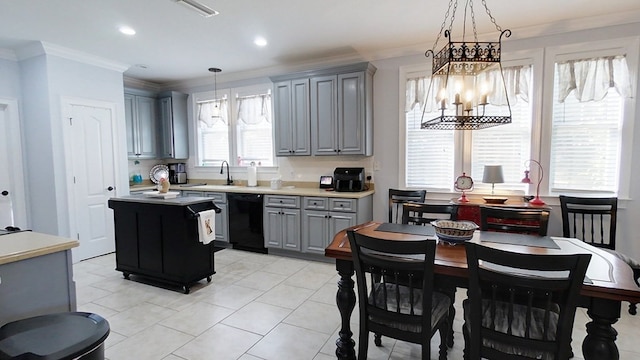 kitchen with ornamental molding, a notable chandelier, dishwasher, a center island, and hanging light fixtures