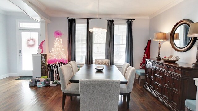 dining space featuring crown molding, dark hardwood / wood-style flooring, and an inviting chandelier