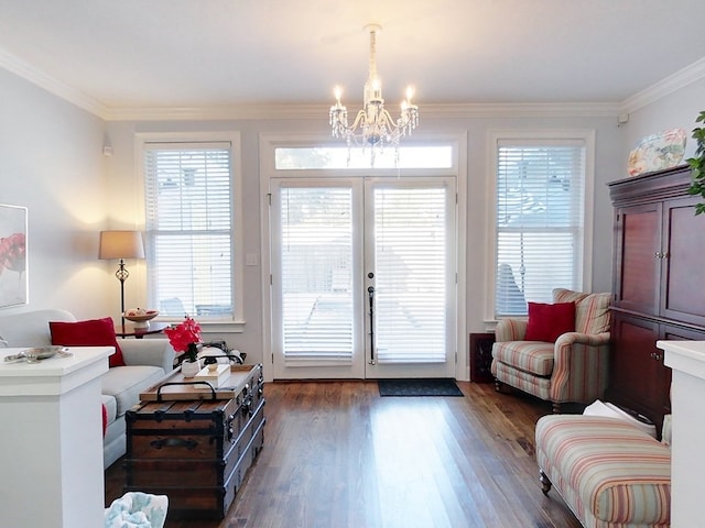 entryway with crown molding, dark wood-type flooring, and an inviting chandelier