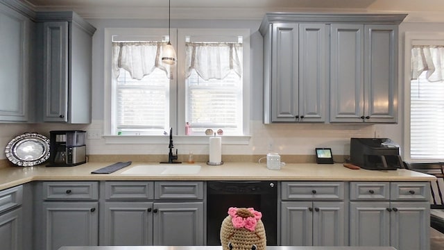 kitchen with decorative backsplash, dishwasher, sink, and hanging light fixtures