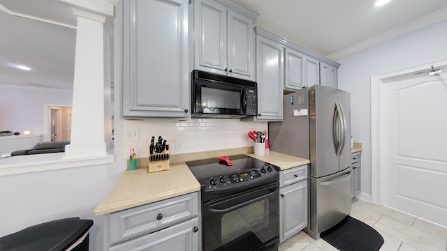 kitchen with gray cabinets, decorative backsplash, light tile patterned floors, black appliances, and ornamental molding