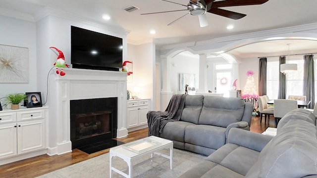 living room with ceiling fan, light hardwood / wood-style floors, and ornamental molding