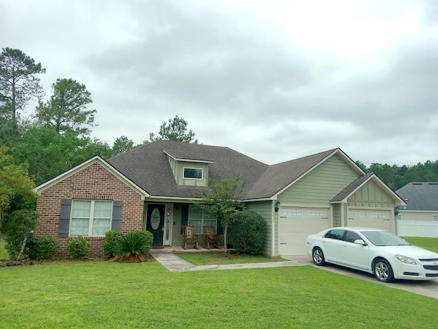 view of front facade with a front yard, a garage, and covered porch