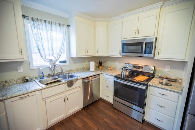 kitchen with sink, white cabinets, and appliances with stainless steel finishes