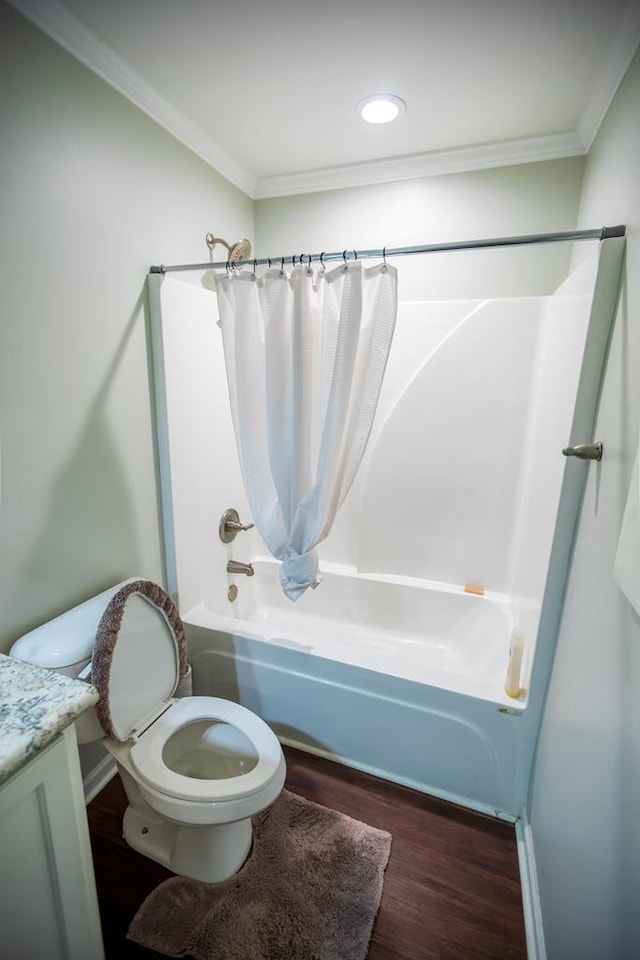 full bathroom featuring wood-type flooring, toilet, vanity, shower / tub combo, and ornamental molding