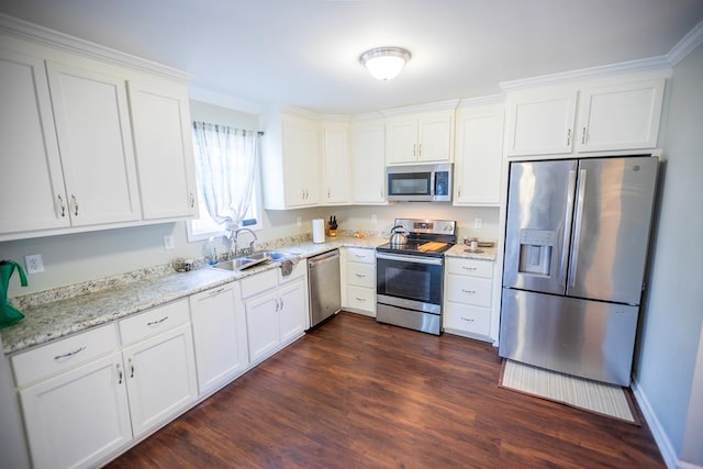 kitchen featuring dark wood-type flooring, white cabinetry, sink, and stainless steel appliances