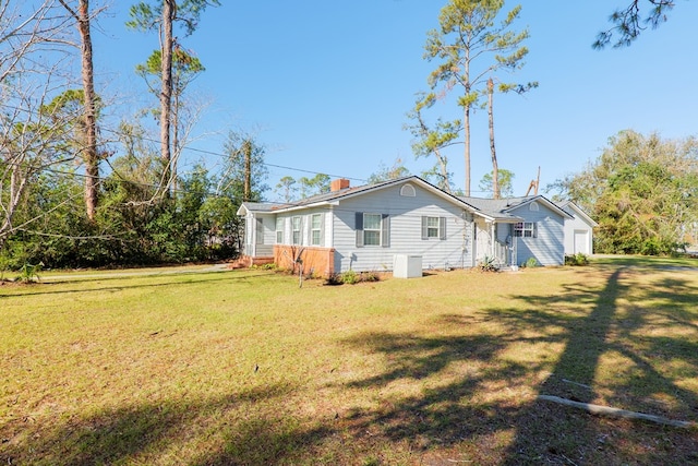 back of property featuring a yard