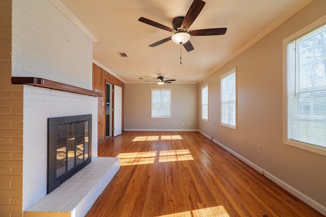 unfurnished living room with a fireplace, light hardwood / wood-style flooring, ceiling fan, and crown molding