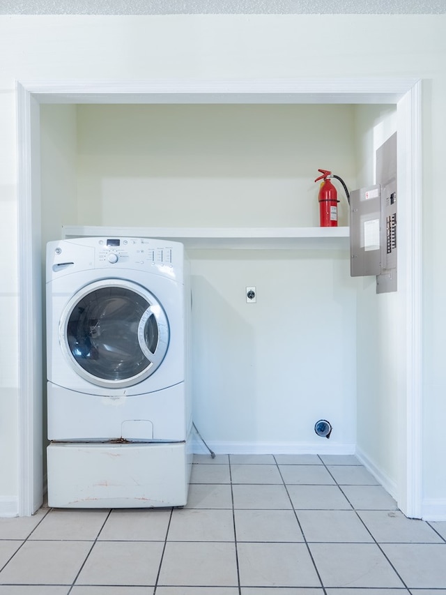 laundry room featuring washer / dryer and light tile patterned floors