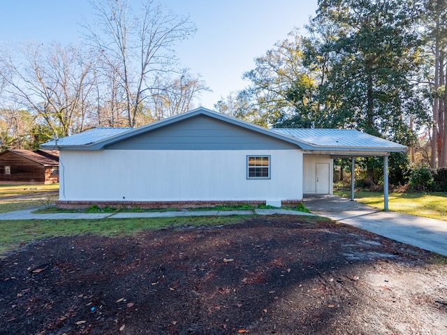 view of side of property with a carport