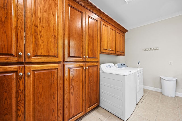 4155 Quail Run Cir, Valdosta, GA 31601 - laundry room with cabinet space, washing machine and clothes dryer, light tile patterned floors, and ornamental molding