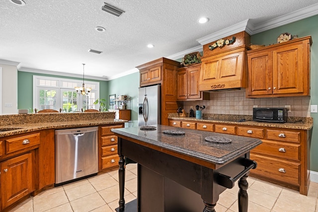 4155 Quail Run Cir, Valdosta, GA 31601 - kitchen featuring black appliances, brown cabinets, a chandelier, ornamental molding, and backsplash