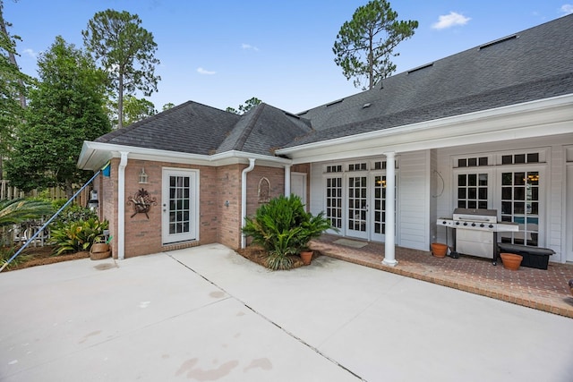 4155 Quail Run Cir, Valdosta, GA 31601 - back of property with french doors, a patio, brick siding, and a shingled roof