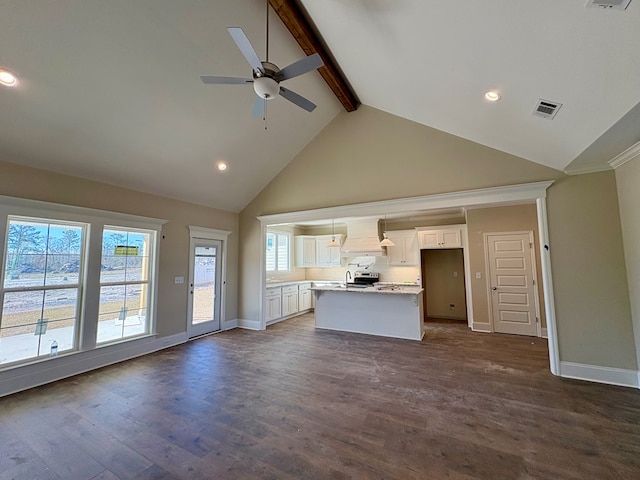 unfurnished living room featuring beam ceiling, dark wood finished floors, visible vents, and baseboards