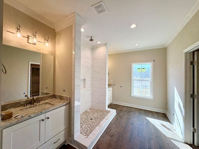 bathroom featuring baseboards, visible vents, wood finished floors, walk in shower, and crown molding