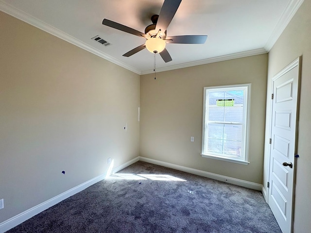 carpeted empty room with baseboards, visible vents, ceiling fan, and crown molding