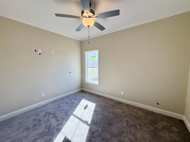 spare room with carpet flooring, crown molding, baseboards, and ceiling fan