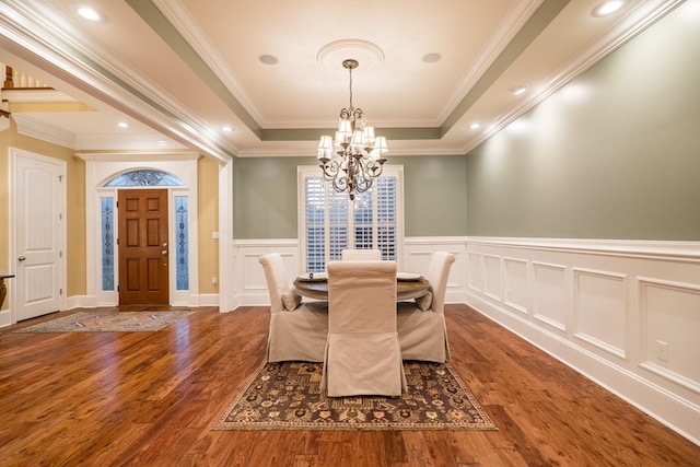 dining room featuring recessed lighting, a notable chandelier, ornamental molding, dark wood-style floors, and a raised ceiling