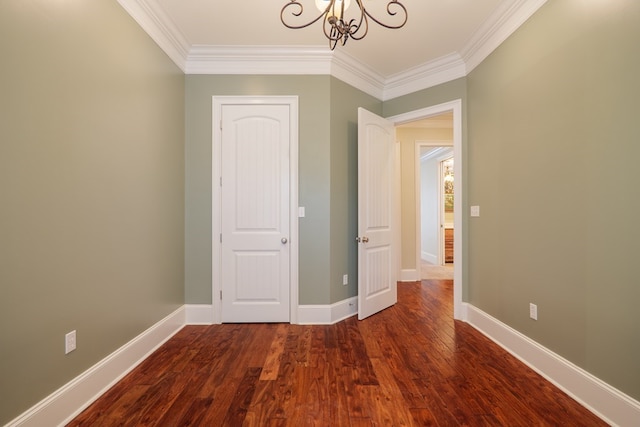 interior space with a notable chandelier, baseboards, ornamental molding, and wood finished floors