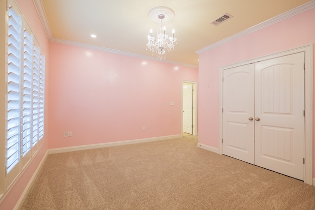 unfurnished bedroom featuring a chandelier, light colored carpet, visible vents, and ornamental molding